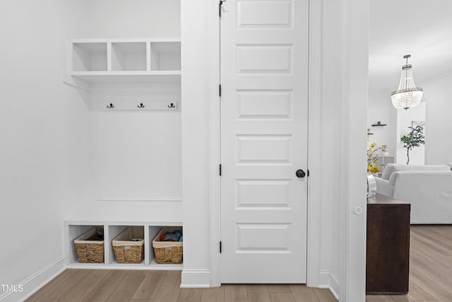 mudroom with wood finished floors and baseboards