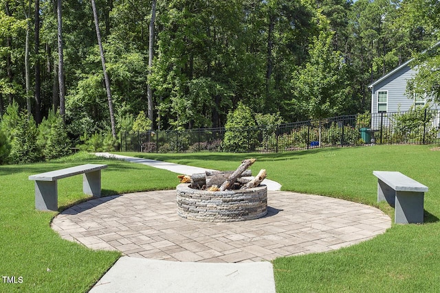 view of patio / terrace with fence and a fire pit