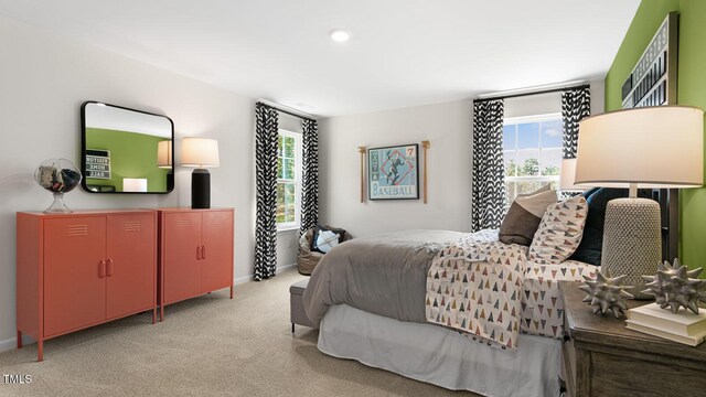 carpeted bedroom with multiple windows