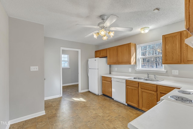 kitchen with ceiling fan, sink, a textured ceiling, and white appliances