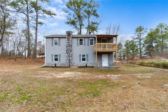 rear view of property featuring a balcony