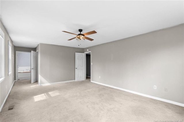 unfurnished bedroom featuring light colored carpet, visible vents, and baseboards