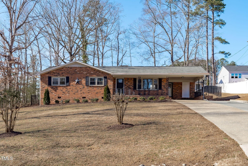 single story home with a carport, covered porch, and a front yard