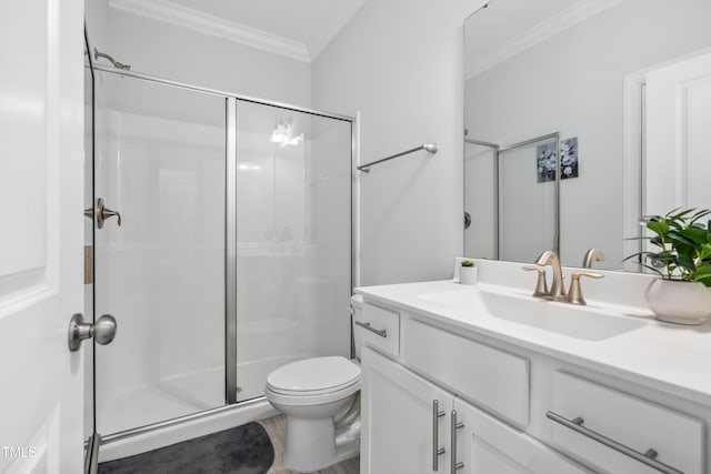 bathroom featuring ornamental molding, vanity, an enclosed shower, and toilet