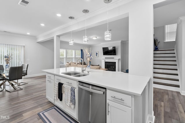 kitchen with an island with sink, sink, dishwasher, white cabinets, and hanging light fixtures