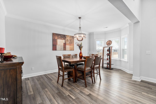 dining area featuring a notable chandelier, dark hardwood / wood-style floors, and ornamental molding