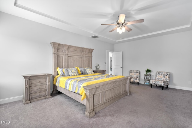 bedroom with carpet flooring, ceiling fan, and a raised ceiling
