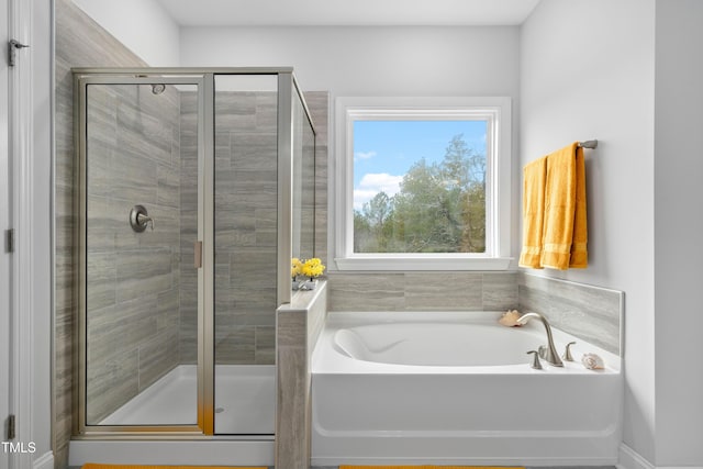 bathroom with separate shower and tub
