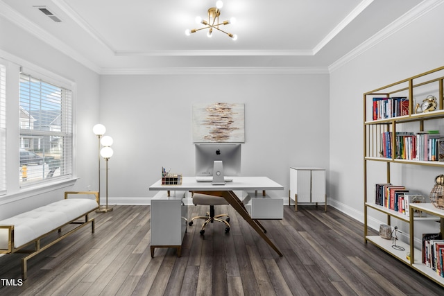 office featuring a raised ceiling, dark wood-type flooring, a notable chandelier, and ornamental molding