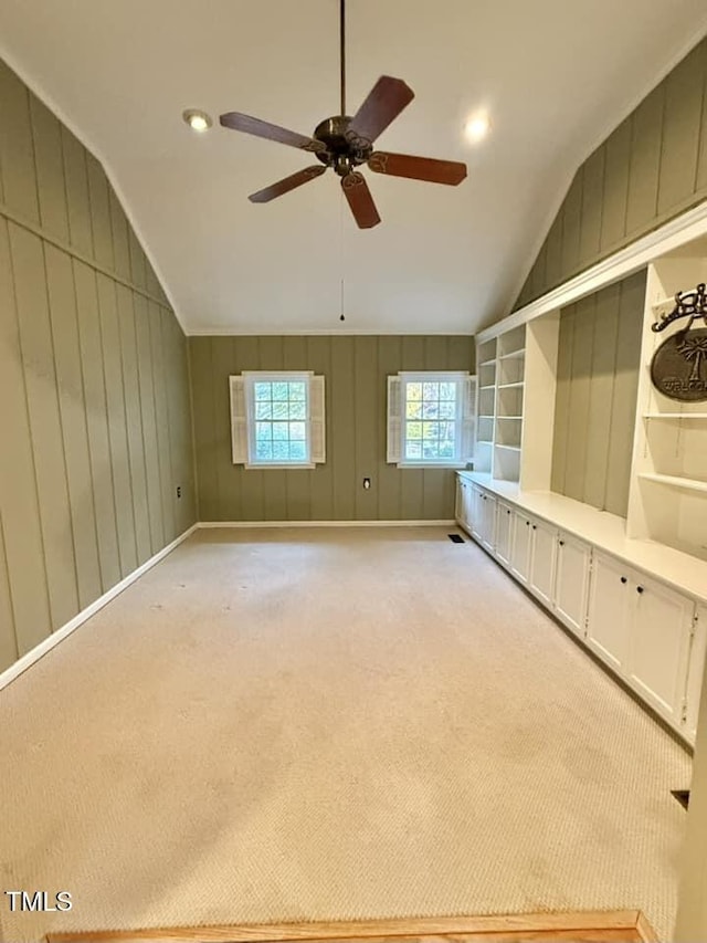 carpeted empty room featuring lofted ceiling and ceiling fan