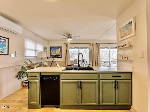 kitchen with sink, an AC wall unit, dishwasher, green cabinets, and kitchen peninsula