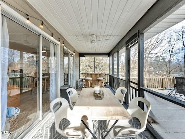 sunroom / solarium featuring wood ceiling and a wealth of natural light