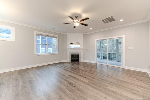 unfurnished living room featuring light hardwood / wood-style floors, ceiling fan, and ornamental molding