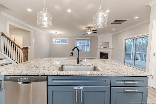 kitchen featuring crown molding, pendant lighting, sink, and stainless steel dishwasher