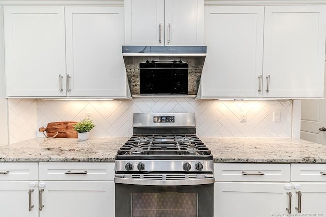 kitchen with white cabinetry, light stone counters, and stainless steel gas range