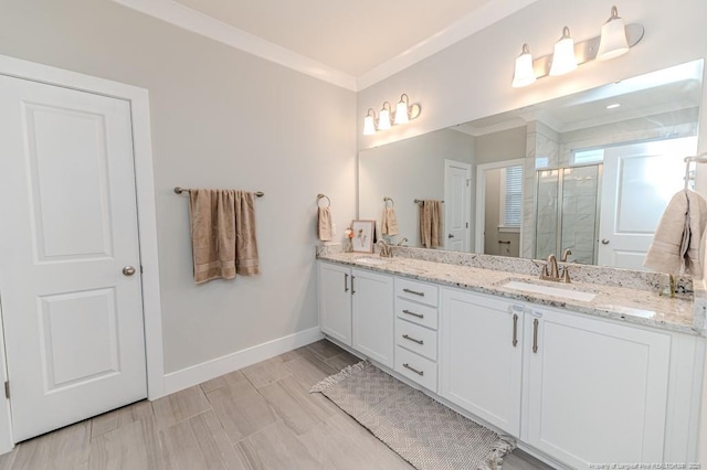 bathroom with ornamental molding, vanity, and walk in shower