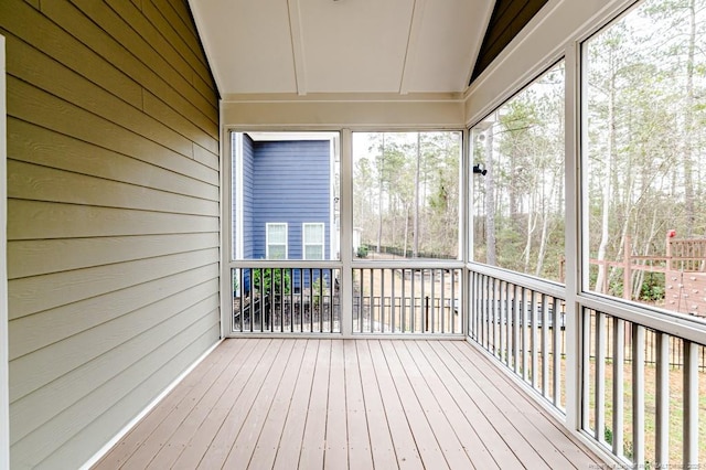 unfurnished sunroom with vaulted ceiling