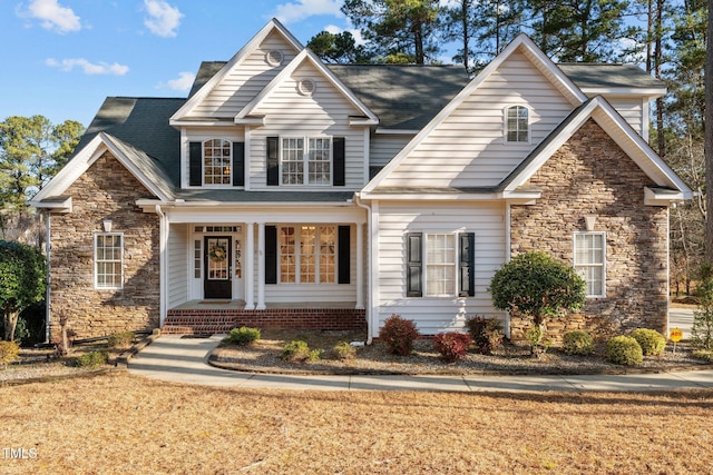 view of front of property with stone siding and a front yard