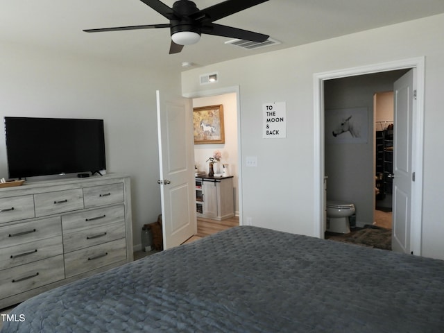 bedroom with ensuite bath and ceiling fan