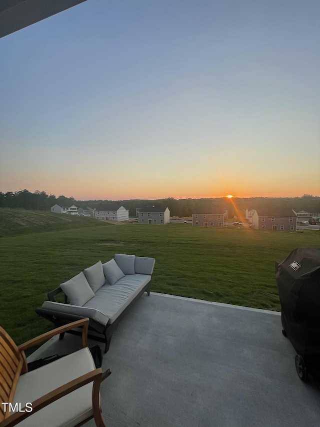 patio terrace at dusk with a lawn