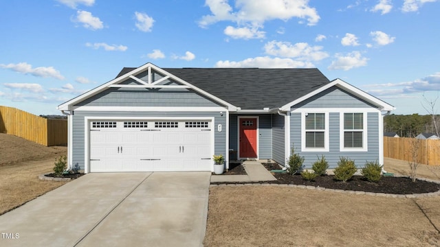 single story home with concrete driveway, fence, and an attached garage