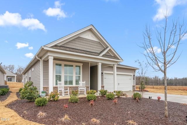 craftsman inspired home with a garage and a porch