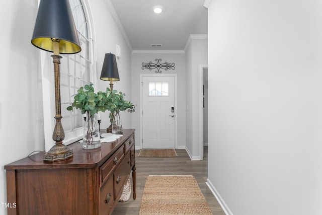 entryway with hardwood / wood-style floors and crown molding