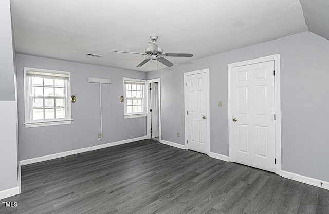 interior space with dark wood-type flooring and ceiling fan