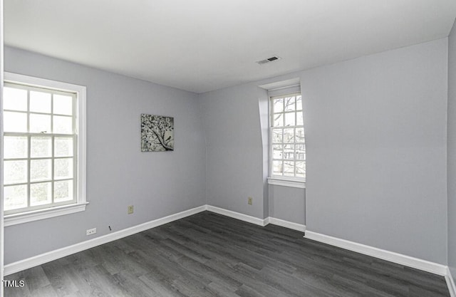 spare room featuring dark wood-type flooring