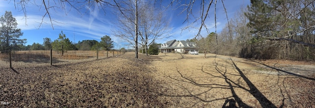 view of street with driveway and a rural view