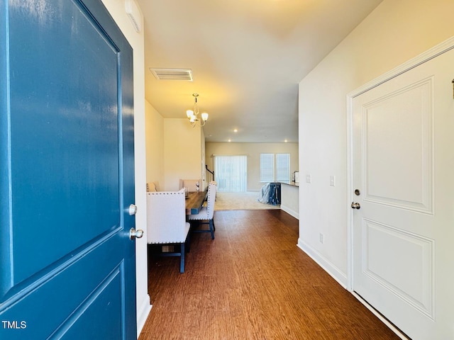 foyer entrance featuring a notable chandelier and hardwood / wood-style flooring