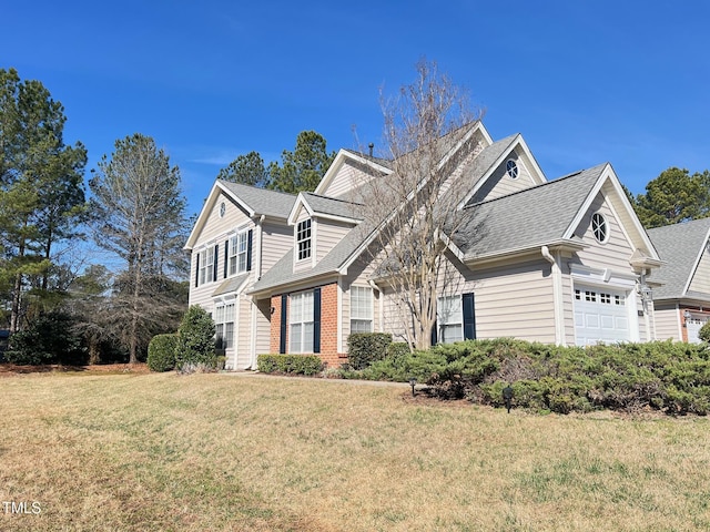 view of front of home with a garage and a front yard