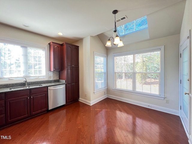 kitchen featuring sink, decorative light fixtures, dark hardwood / wood-style flooring, dishwasher, and light stone countertops