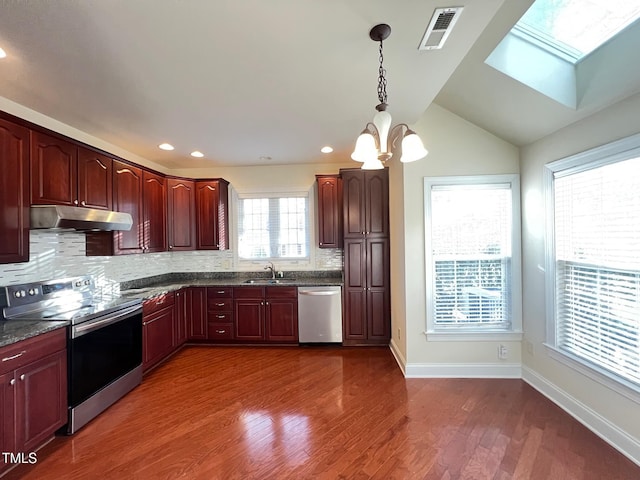 kitchen featuring pendant lighting, sink, backsplash, dark hardwood / wood-style flooring, and stainless steel appliances