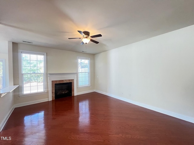 unfurnished living room featuring ceiling fan and dark hardwood / wood-style floors