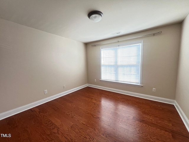 empty room featuring dark wood-type flooring