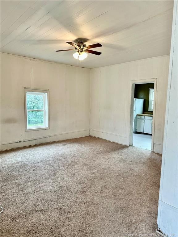 carpeted empty room with ceiling fan