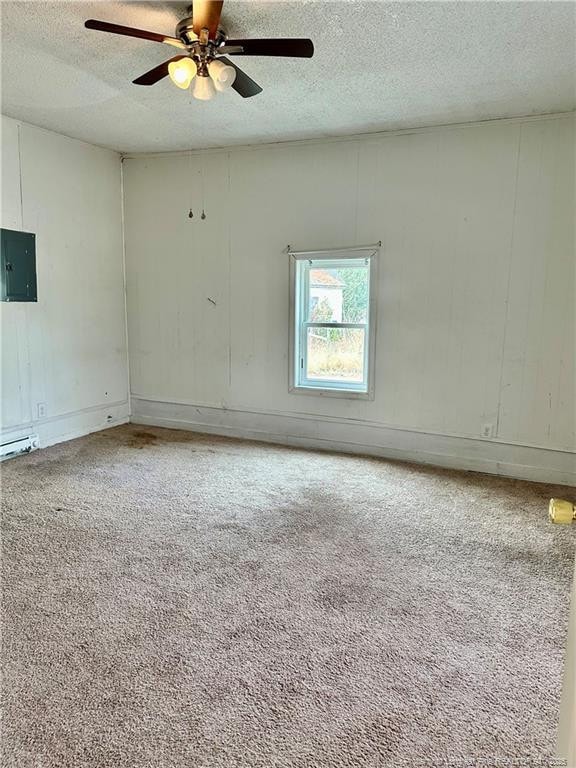 unfurnished room with ceiling fan, carpet flooring, electric panel, and a textured ceiling