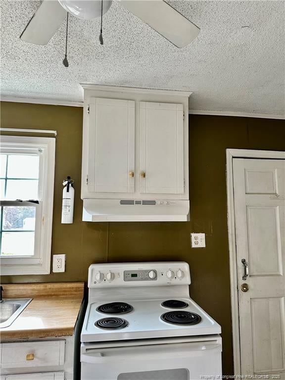 kitchen featuring white cabinets, sink, a textured ceiling, and white range with electric stovetop