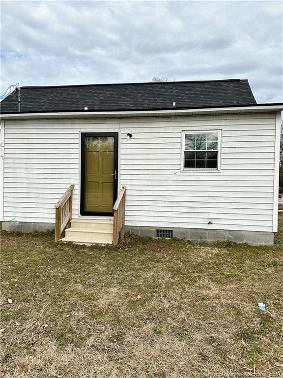 rear view of house with a lawn