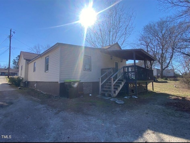 exterior space with stairs and a deck