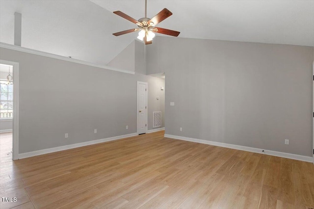 empty room featuring high vaulted ceiling, light wood-style flooring, baseboards, and a ceiling fan