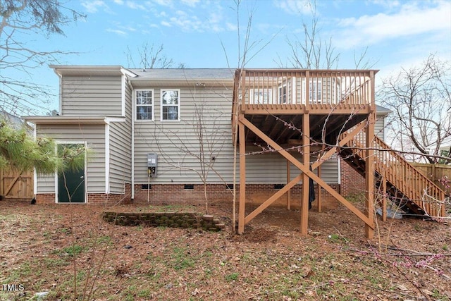 back of property with crawl space, a deck, and stairs