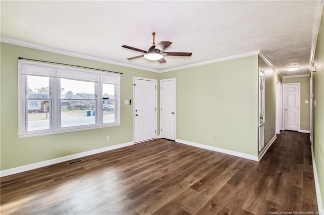 unfurnished room with crown molding, dark hardwood / wood-style floors, and ceiling fan