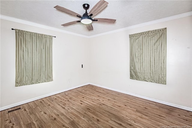 empty room featuring ceiling fan, ornamental molding, hardwood / wood-style floors, and a textured ceiling