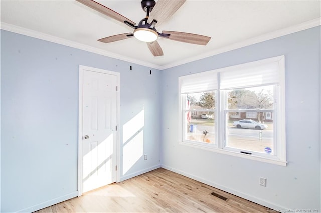 spare room featuring crown molding, ceiling fan, and light hardwood / wood-style flooring