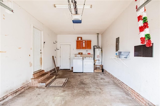 garage with a garage door opener, washer and dryer, and gas water heater