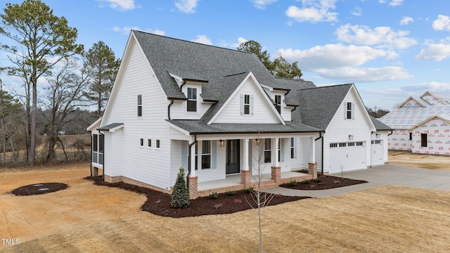 view of front facade with a porch and a garage