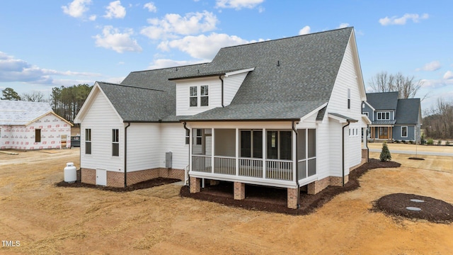 back of house featuring a sunroom