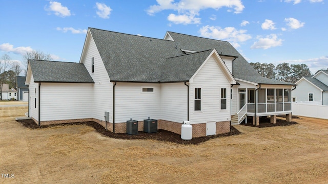 back of house featuring a sunroom and central air condition unit